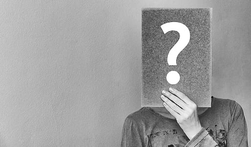 grayscale picture of a person holding question mark signboard thumbnail