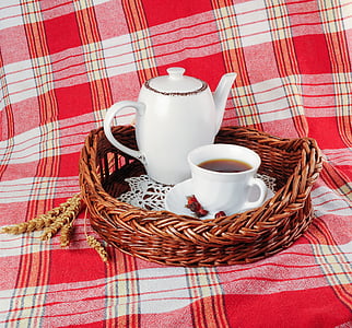white ceramic teapot and cup of coffee on brown wicker tray thumbnail