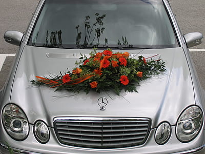 red flower arrangement on silver Mercedes Benz car thumbnail
