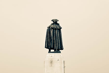man in black cape concrete statue thumbnail