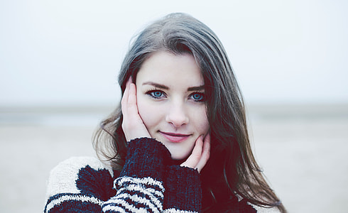 woman holding face during daytime thumbnail