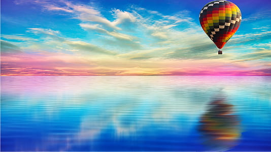 multicolored hot air balloon reflection on water thumbnail