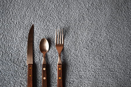 brown handled cutlery on grey surface thumbnail