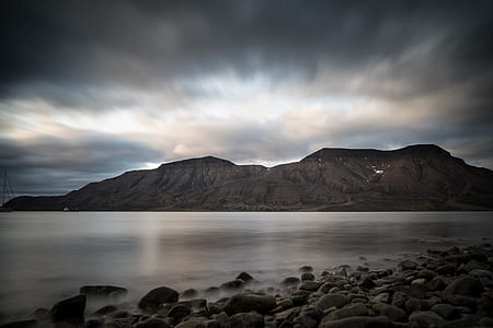 rippling body of water near rocks thumbnail