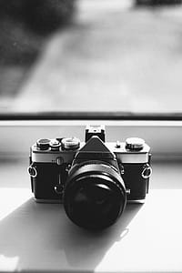 Grayscale Photography of Olympus Dslr Camera Near the Mirror thumbnail