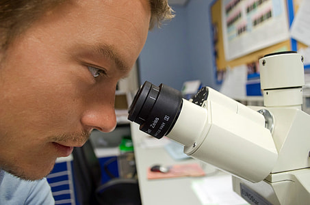 photo of man looking at microscope thumbnail