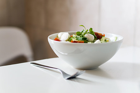 salad on white ceramic bowl beside silver fork thumbnail