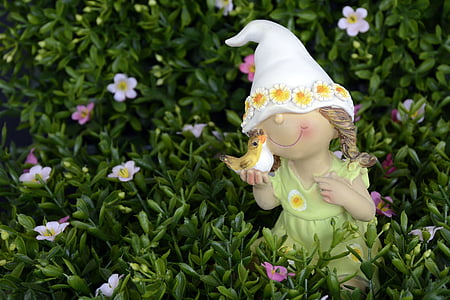 elf holding bird figurine on grass thumbnail