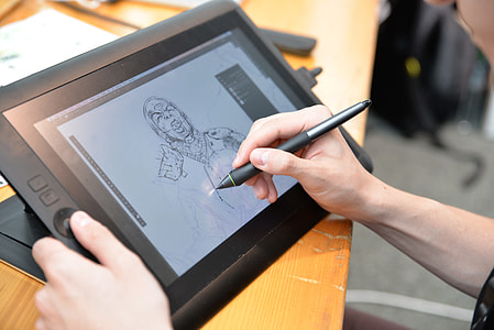 person holding black tablet computer and pen thumbnail