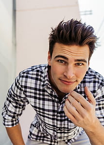 close up photography of man wearing plaid sport shirt leaning forward thumbnail