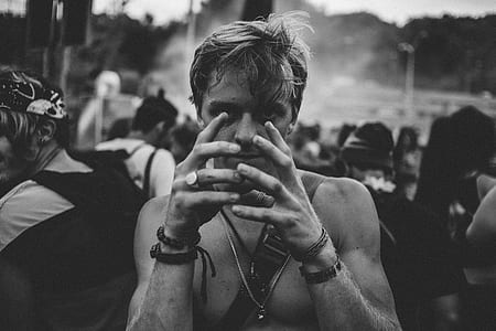 grayscale photo of man showing hands thumbnail