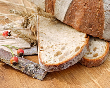sliced bread beside wood sticks on brown wooden surface thumbnail