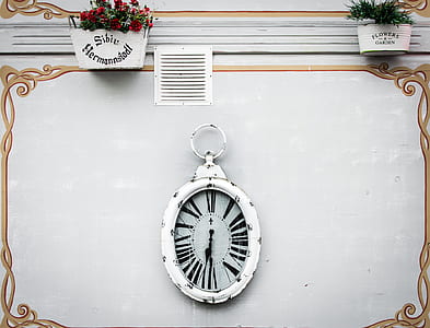 white and black analog wall clock at 7:30 thumbnail