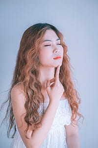 woman wearing white tube dress pointing her chin thumbnail