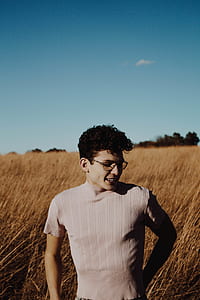 man in gray top standing on brown farm thumbnail