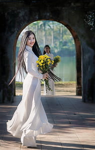 woman holding yellow flowers thumbnail
