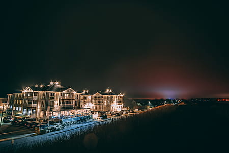 White Concrete Building Beside Body of Water during Nighttime thumbnail