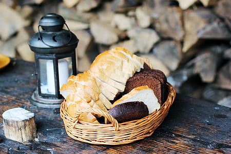 baked bread in basket near candle lantern thumbnail