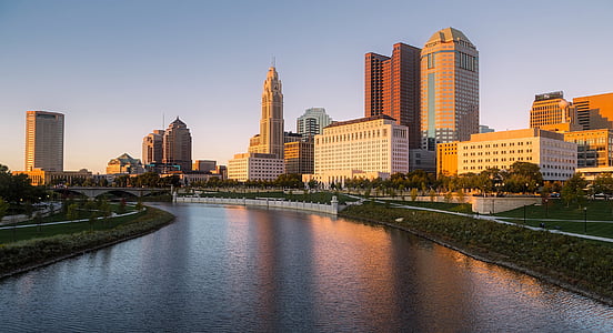concrete buildings near body of water during daytime thumbnail