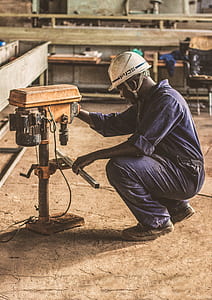 man holding orange drill press thumbnail