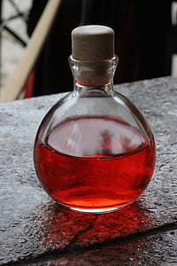 close-up photo of clear glass bottle with red liquid thumbnail