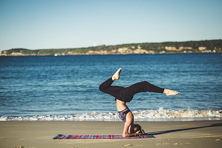 woman doing yoga at beach thumbnail