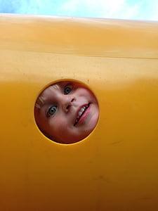boy face on hole during daytime thumbnail