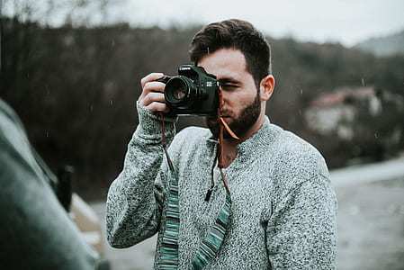 selective photo of man taking photo thumbnail