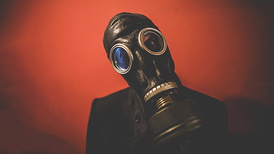 person wearing black gas mask while taking selfie thumbnail