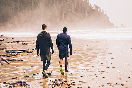 two men waking beside body of water thumbnail
