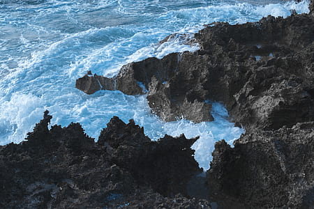 coastal rocks surround by rough water thumbnail