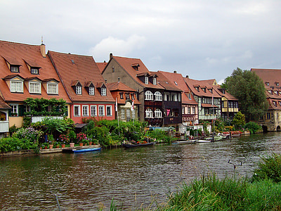 brown and black houses beside body of water thumbnail