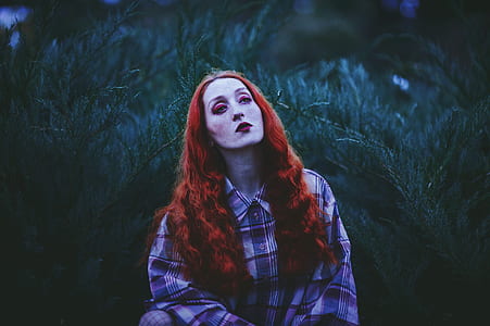 red hair woman standing in front of green grass thumbnail