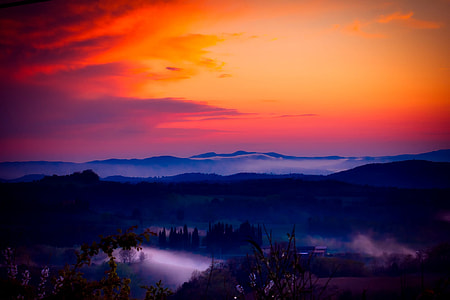 silhouette of mountain at mist during sunset thumbnail