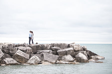 couple standing on coastal rocks thumbnail