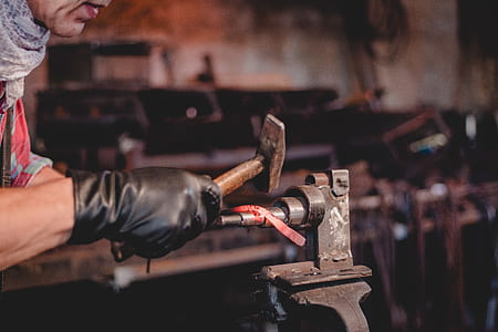 person holding gray steel hammer thumbnail