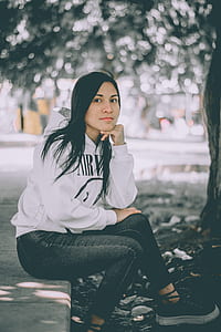 woman sitting near tree thumbnail