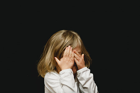 girl covering her face wearing white long-sleeved shirt thumbnail
