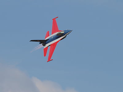 red and blue jet plane flying in the sky thumbnail