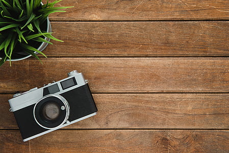 Black and Silver Film Camera on Brown Wooden Surface thumbnail