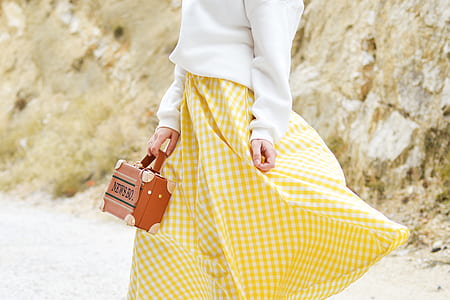 woman holding brown handbag thumbnail