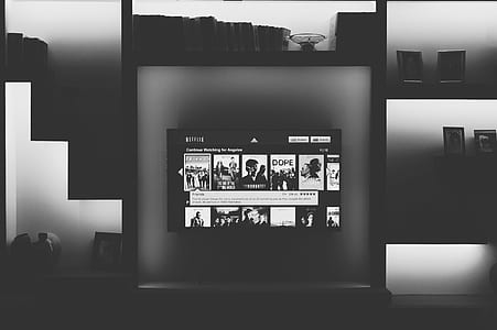 grayscale photography of flat screen smart television turned on thumbnail