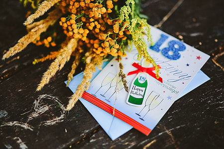Yellow flowers with miscellaneous items on wooden floor thumbnail