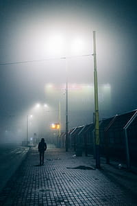 Silhouette of Person Walking on Street thumbnail
