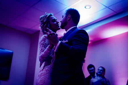 newlywed couple dancing under purple lights thumbnail