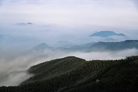 aerial photo of mountain under white clouds thumbnail