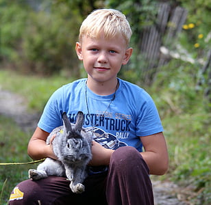 boy carrying gray rabbit thumbnail