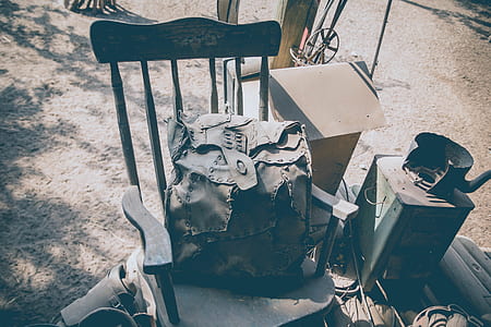 gray backpack on brown wooden racking chair thumbnail