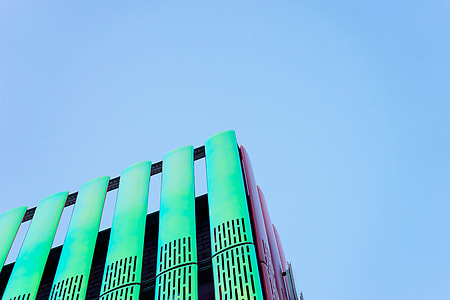 landscape photography of green and pink high rise building thumbnail