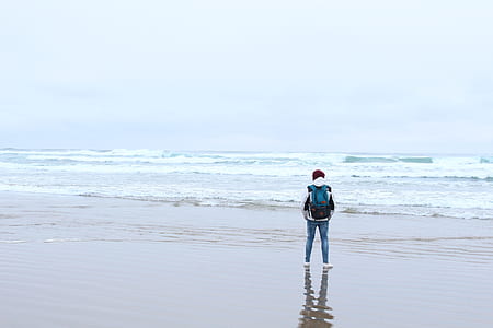 person standing on sea shore thumbnail